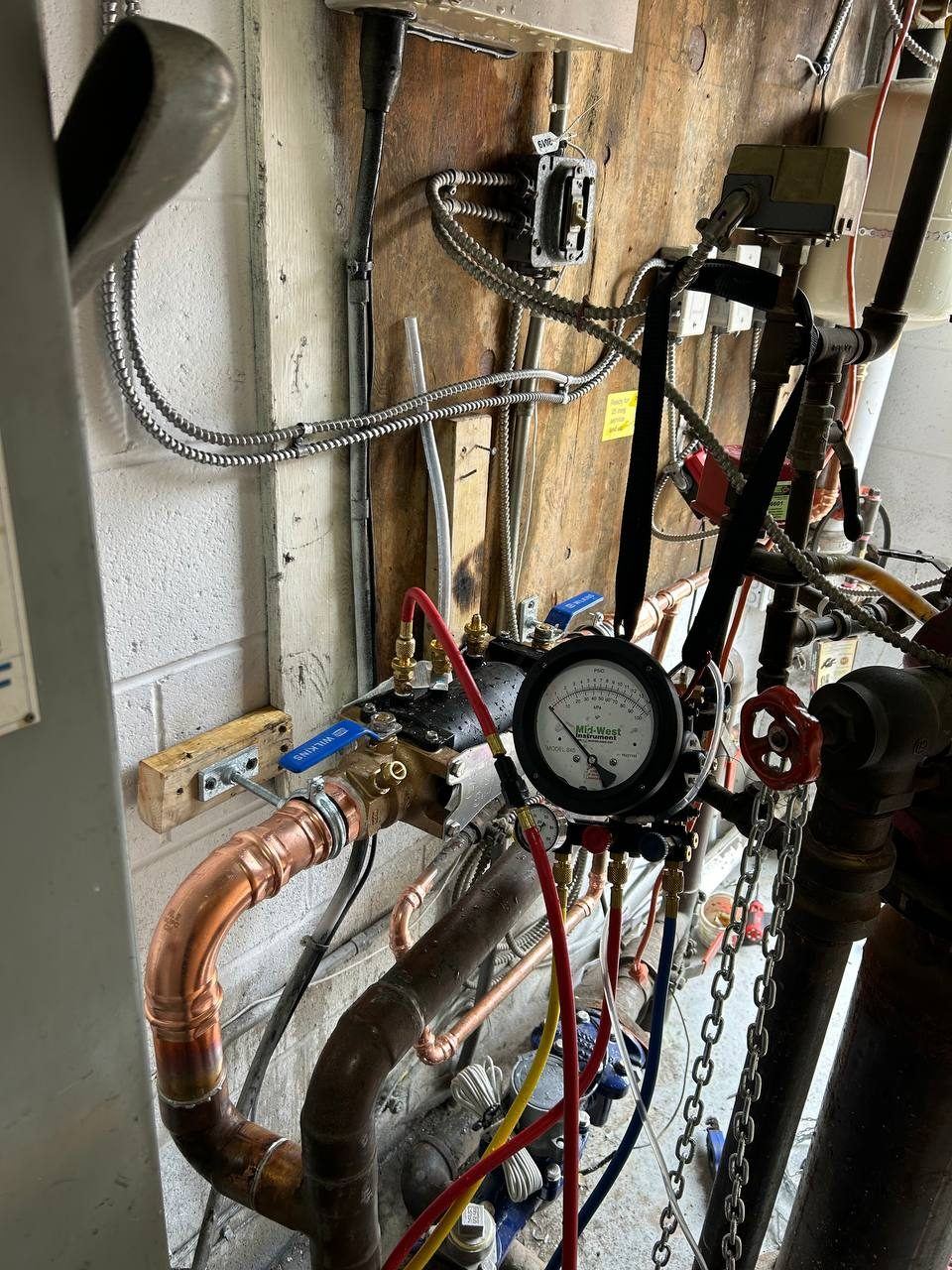 Certified backflow preventer test in progress on a commercial property in Aurora